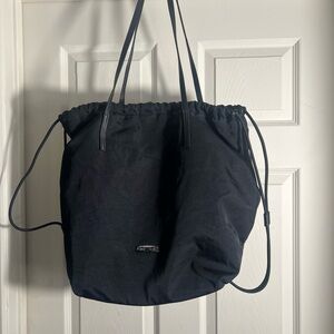 Thirty Years black ROVE drawstring shoulder bag featuring a cinched closure